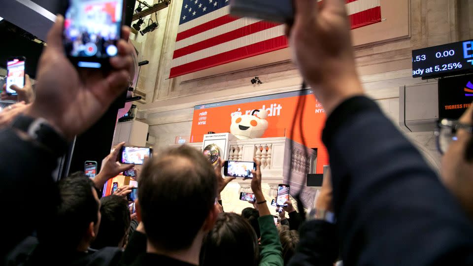 Snoo, mascot of Reddit Inc., rings the opening bell during the company's initial public offering (IPO) on the floor of the New York Stock Exchange on Thursday, March 21, 2024. Reddit Inc. and its selling shareholders raised $748 million, pricing shares in an initial public offering at the top of a marketed range, the second big tech listing in as many days. - Michael Nagle/Bloomberg/Getty Images