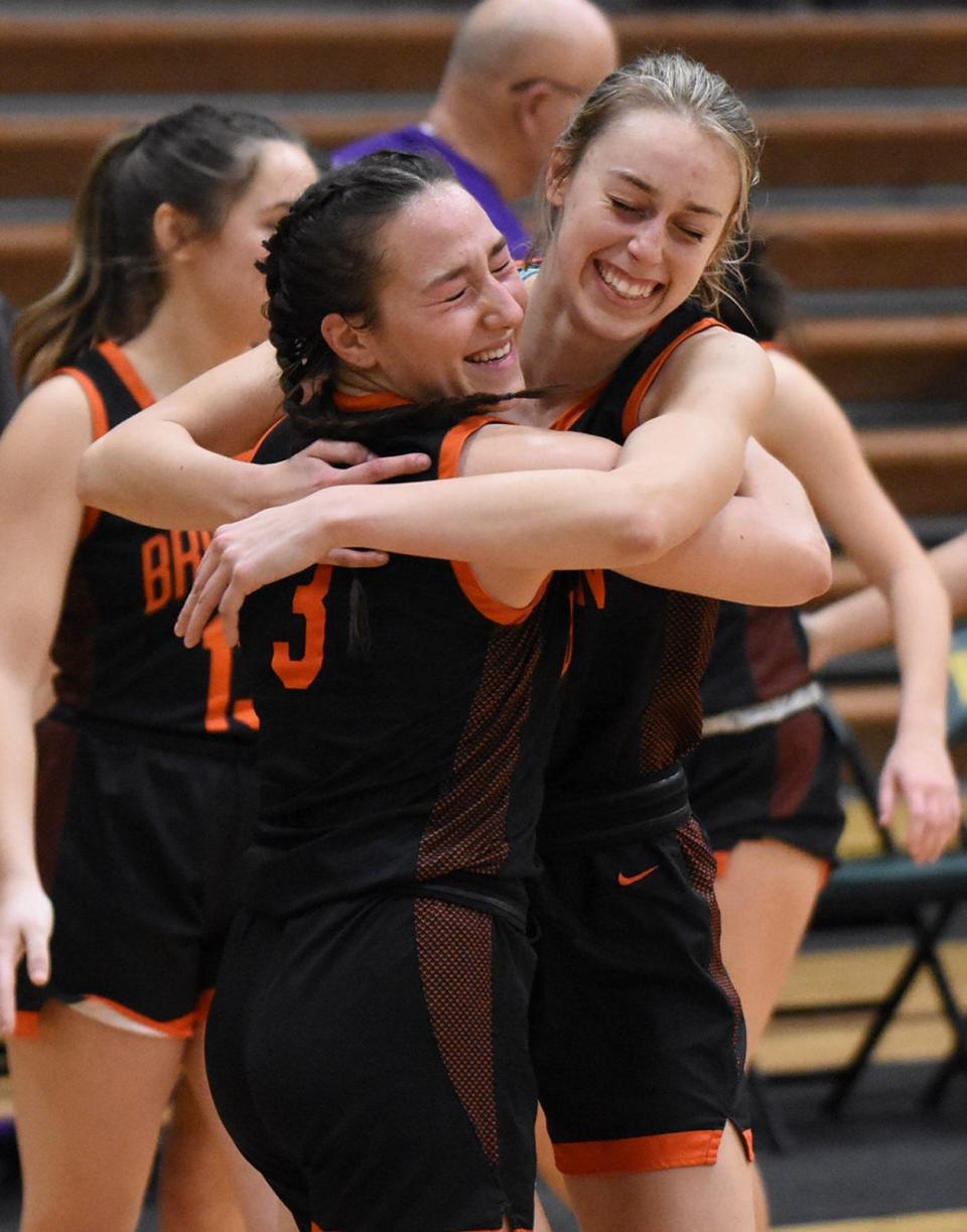 Brighton's Mary Copple (3) and Makena Smith celebrate a 57-41 victory over Howell on Tuesday, Jan. 10, 2023.