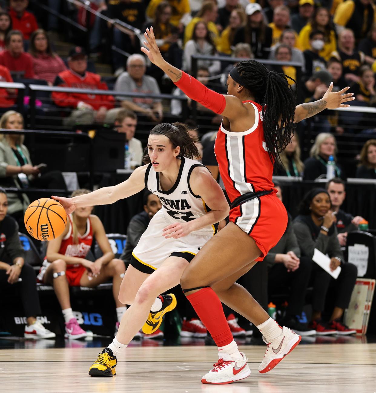 Mar 5, 2023; Minneapolis, MINN, USA; Iowa Hawkeyes guard Caitlin Clark (22) dribbles while Ohio State Buckeyes forward Cotie McMahon (32) defends during the first half at Target Center. Mandatory Credit: Matt Krohn-USA TODAY Sports