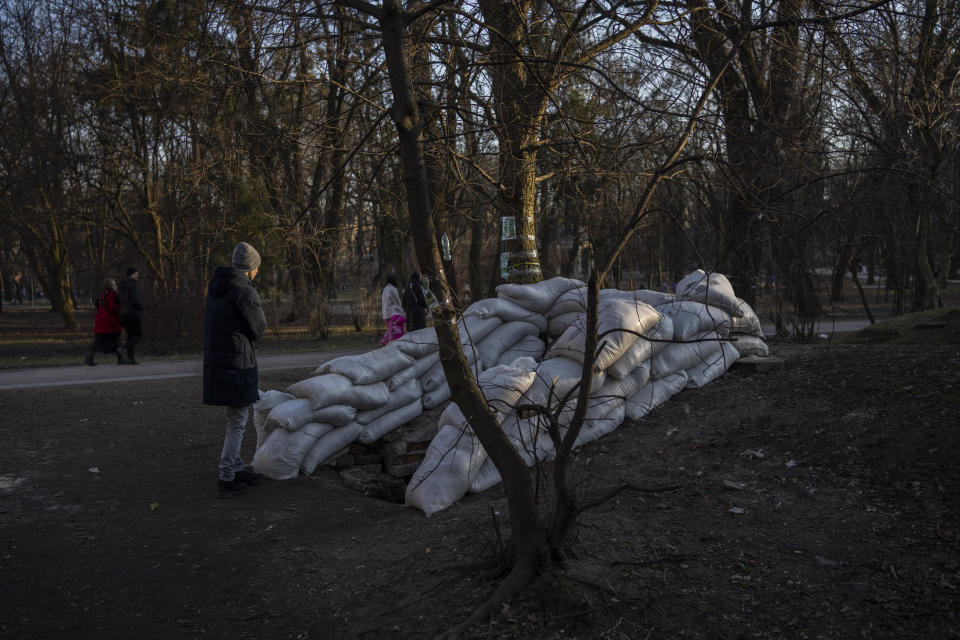 A man stands in front of a bomb shelter in Lviv, Western Ukraine, Saturday, March 19, 2022. Fighting raged on multiple fronts in Ukraine more than three weeks after Russia's Feb. 24 invasion. U.N. bodies have confirmed more than 800 civilian deaths since the war began but say the real toll is considerably higher. The U.N. says more than 3.3 million people have fled Ukraine as refugees. (AP Photo/Bernat Armangue)