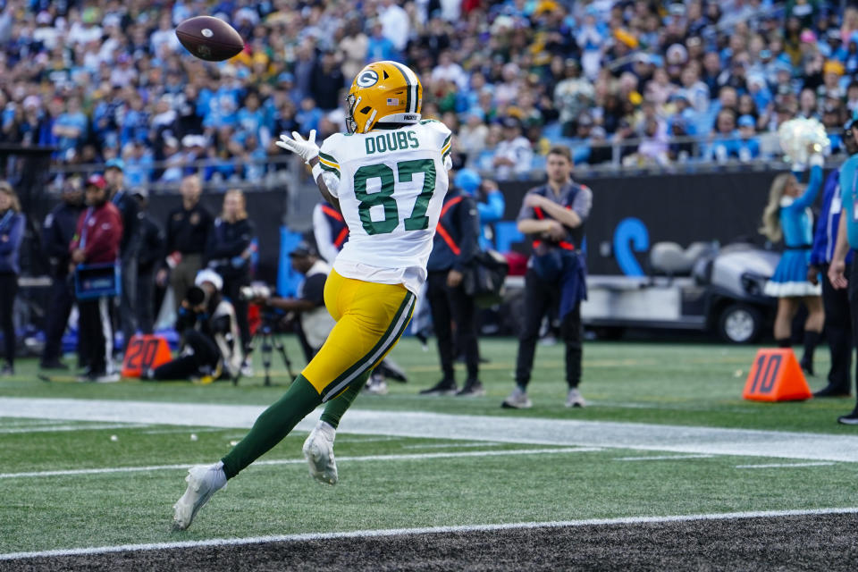 Green Bay Packers wide receiver Romeo Doubs scores against the Carolina Panthers during the first half of an NFL football game Sunday, Dec. 24, 2023, in Charlotte, N.C. (AP Photo/Jacob Kupferman)