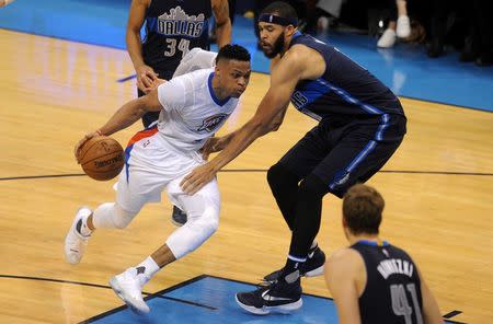 Apr 16, 2016; Oklahoma City, OK, USA; Oklahoma City Thunder guard Russell Westbrook (0) drives to the basket defended by Dallas Mavericks center JaVale McGee (11) during the second quarter of game one of their first round NBA Playoffs series at Chesapeake Energy Arena. Mandatory Credit: Mark D. Smith-USA TODAY Sports