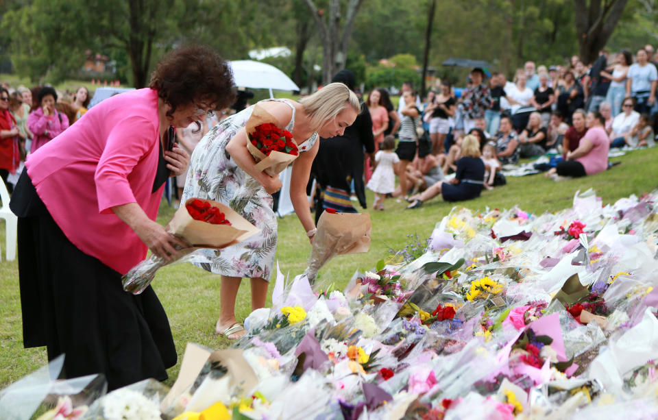 The public leave flowers at the vigil for Hannah Clarke.