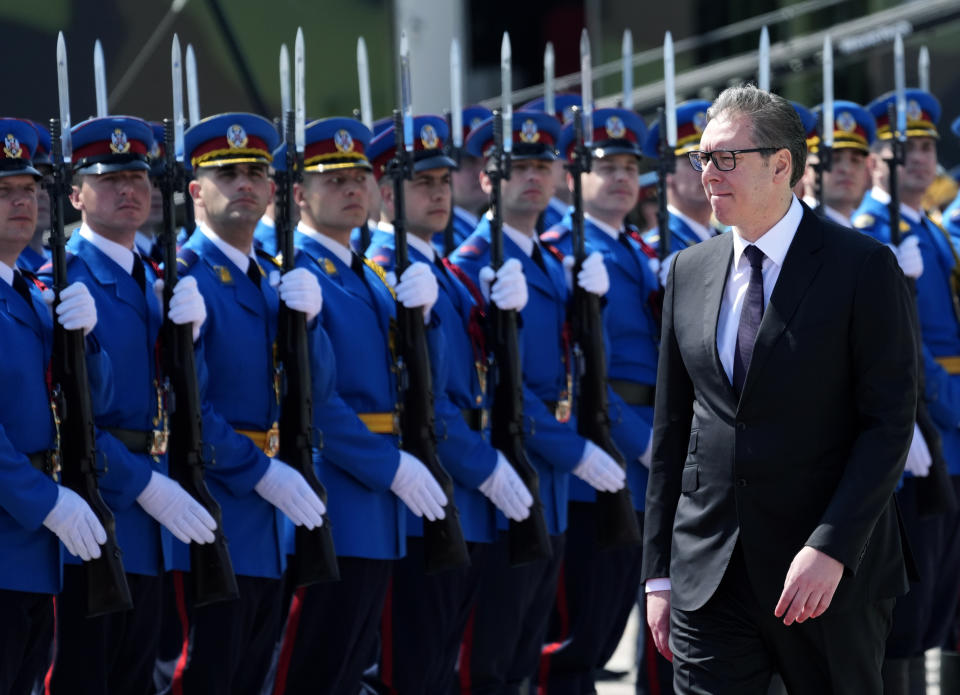 Serbian President Aleksandar Vucic reviews the honor guard during a welcome ceremony before the military exercises on Batajnica, military airport near Belgrade, Serbia, Saturday, April 30, 2022. Although Serbia officially seeks membership in the European Union, it has been arming itself mostly with Russian and Chinese weapons, including T-72 battle tanks, MiG-29 fighter jets, Mi-35 attack helicopters and drones. (AP Photo/Darko Vojinovic)