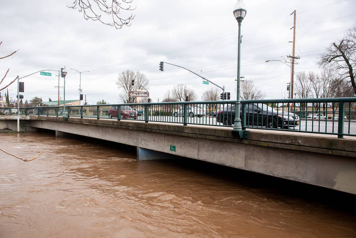 Bear Creek flows past G Street flooding the Michael O. Sullivan bike path and the surrounding area in Merced, Calif, on Tuesday, Jan. 10, 2023.