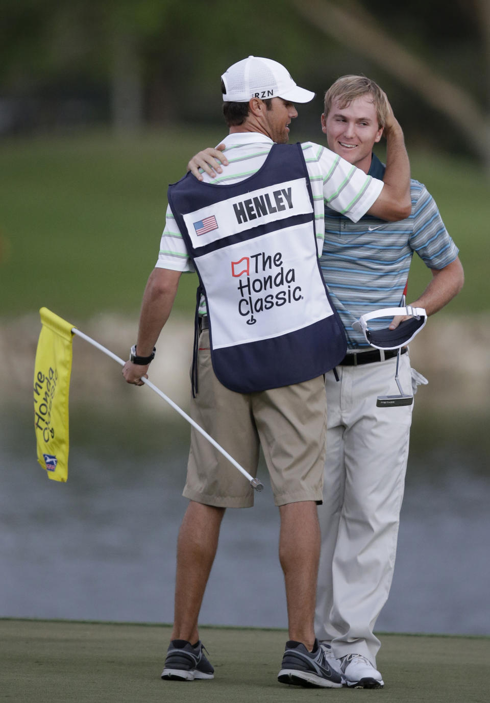 Russell Henley, right, hugs his caddie after winning the Honda Classic golf tournament, Sunday, March 2, 2014 in Palm Beach Gardens, Fla. (AP Photo/Wilfredo Lee)