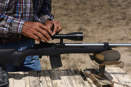 Bill Martin, 72, prepares to shoot a Ruger Mini-14 rifle on his ranch near Carizzo Springs, Texas, U.S. September 5, 2018. REUTERS/Callaghan O'Hare