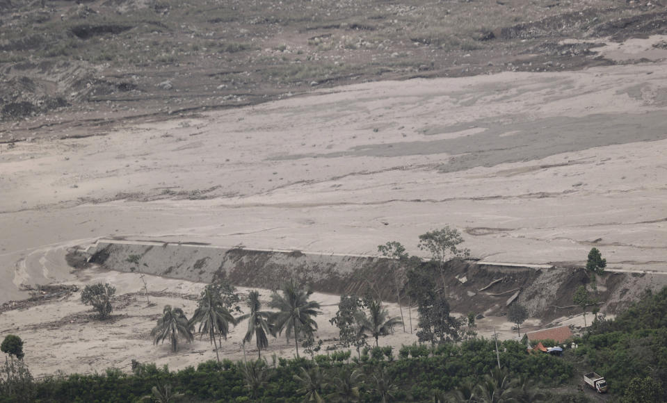 The ash from the eruption of Mount Semeru are seen in Lumajang, East Java, Indonesia, Sunday, Dec. 5, 2021. The death toll from eruption of the highest volcano on Indonesia's most densely populated island of Java has risen with scores still missing, officials said Sunday as rain continued to pound the region and hamper the search.(AP Photo/Trisnadi)