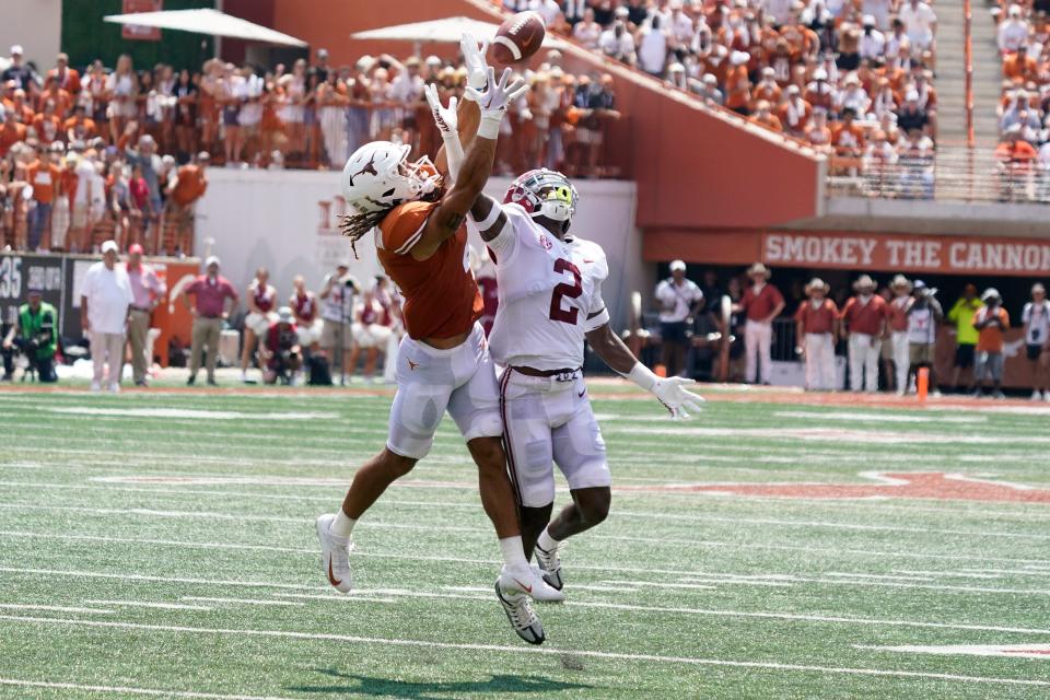 Alabama defensive back DeMarcco Hellams (2) breaks up a pass intended for Texas wide receiver Jordan Whittington (4) during the second half at Darrell K Royal-Texas Memorial Stadium.