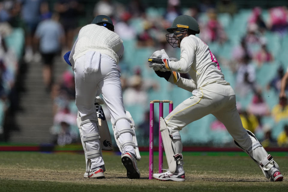 Australia's Alex Carey, right, catches out South Africa's Marco Jansen during the fifth day of their cricket test match at the Sydney Cricket Ground in Sydney, Sunday, Jan. 8, 2023. (AP Photo/Rick Rycroft)