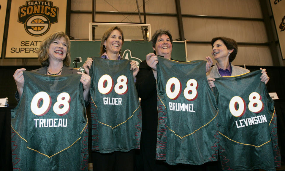 FILE - New Seattle Storm owners Dawn Trudeau, Ginny Gilder, Lisa Brummel and Anne Levinson, from left, hold team jerseys with their names as they pose following a news conference announcing the planned purchase Tuesday, Jan. 8, 2008, in Seattle. As Title IX marks its 50th anniversary this year, Gilder is one of countless women who benefited from the enactment and execution of the law, translating those opportunities into becoming leaders in their professional careers. (AP Photo/Elaine Thompson, FIle)