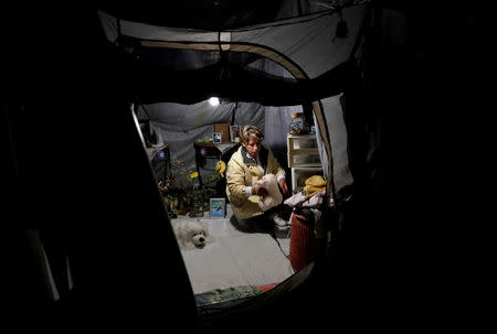 Maria Guadalupe Padilla is pictured inside her tent in the Tlalpan neighbourhood, near the site where her building was damaged by the devastating earthquake, that took place in Mexico City last year, Mexico, August 31, 2018. Picture taken August 31, 2018. REUTERS/Henry Romero