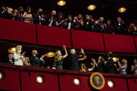 President Joe Biden and first lady Jill Biden turn to wave to the upper balcony as they arrive for the 44th Kennedy Center Honors at the John F. Kennedy Center for the Performing Arts in Washington, Sunday, Dec. 5, 2021. Also seen are Vice President Kamala Harris, and second gentleman Doug Emhoff, 2021 Kennedy Center honorees Motown Records creator Berry Gordy, and actress-singer Bette Midler. (AP Photo/Carolyn Kaster)