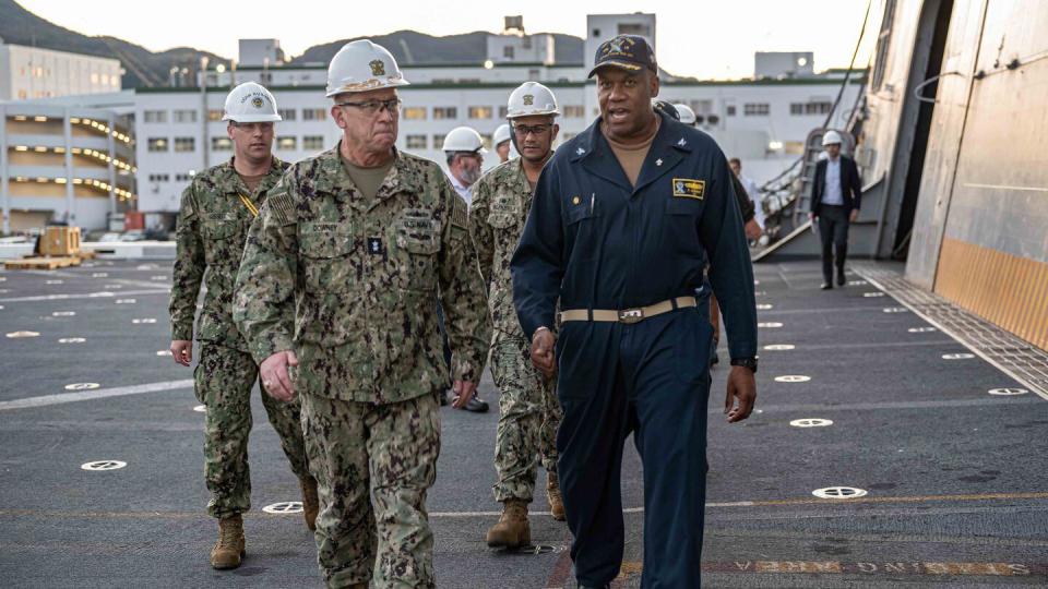 Captain Patrick German, the forward-deployed amphibious transport dock ship USS New Orleans’ (LPD 18) commanding officer, escorts Rear Admiral James Downey, Special Assistant to the Assistant Secretary of the Navy (Research, Development, and Acquisition), to New Orleans’ wardroom during a scheduled visit on Oct. 24, 2023.  (MC1 Desmond Parks./US Navy)