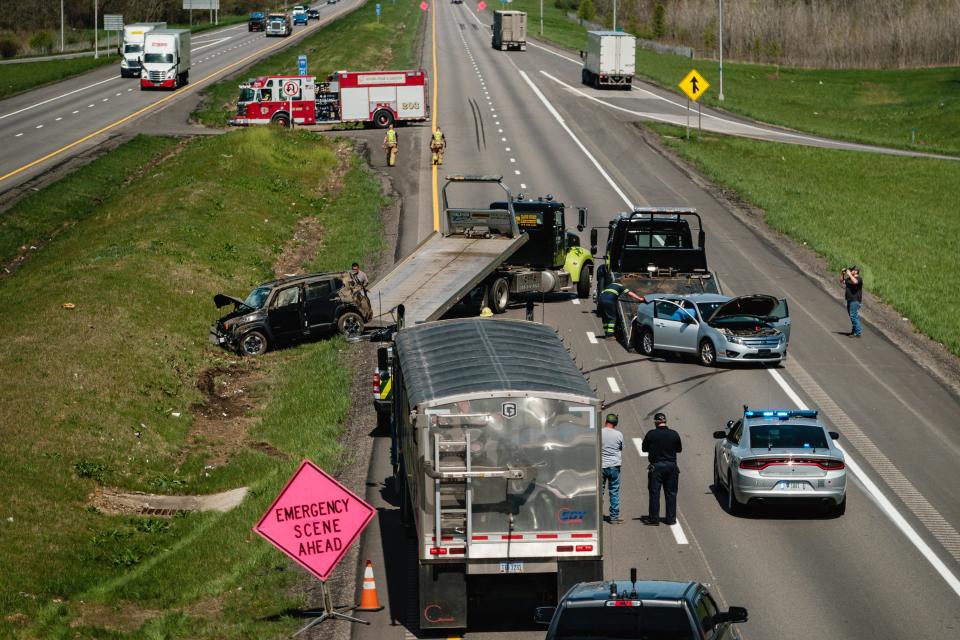 Crews work to clear the scene of a two-vehicle crash that closed down the northbound lanes of I-77 at Schneider's Crossing Road, Tuesday, April 16 in Dover Township.