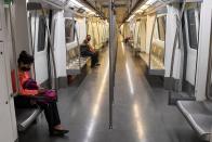 Commuters sit in a carriage of a Yellow Line train after Delhi Metro Rail Corporation (DMRC) resumed services in New Delhi on September 7, 2020.(Photo by PRAKASH SINGH/AFP via Getty Images)