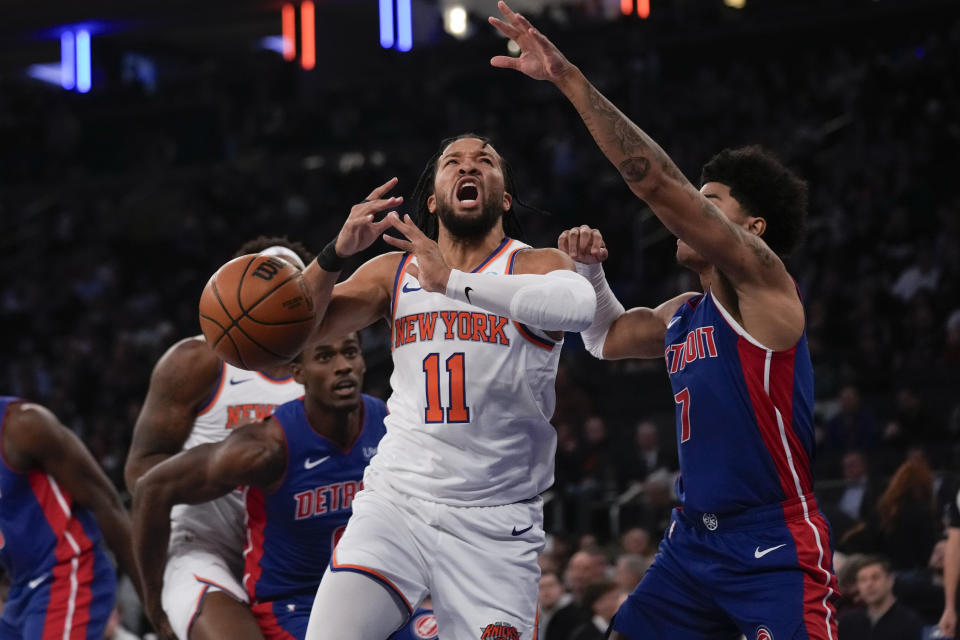 Detroit Pistons' Killian Hayes, right, fouls New York Knicks' Jalen Brunson (11) as he drives to the basket during the first half of an NBA basketball game, Thursday, Nov. 30, 2023, in New York. (AP Photo/Seth Wenig)