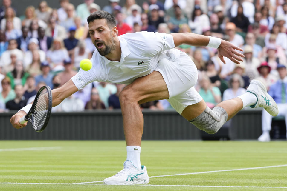 Serbia's Novak Djokovic plays a forehand return to Britain's Jacob Fearnley during their second round match at the Wimbledon tennis championships in London, Thursday, July 4, 2024. (AP Photo/Kirsty Wigglesworth)