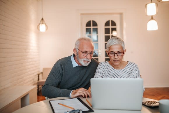 Senior couple at a laptop.