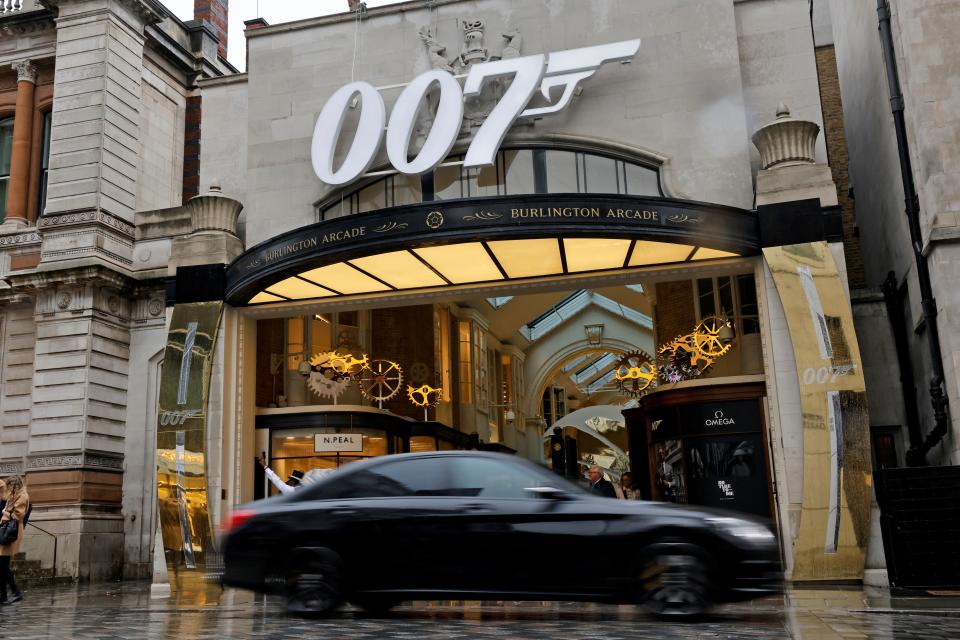 A pedestrian walks past a James Bond 007 logo above the entrance to Burlington Arcade in London on October 4, 2021, following the release of the latest James Bond film 