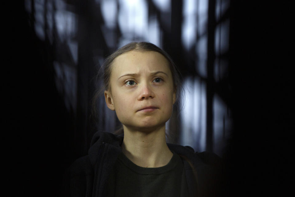 FILE - In this March 5, 2020 file photo, Swedish climate activist Greta Thunberg speaks with the media as she arrives for a meeting of the Environment Council at the European Council building in Brussels. On Friday, June 25, 2021, the Associated Press reported on stories circulating online incorrectly claiming a video shows Thunberg arguing that climate change isn’t real. (AP Photo/Virginia Mayo, File)