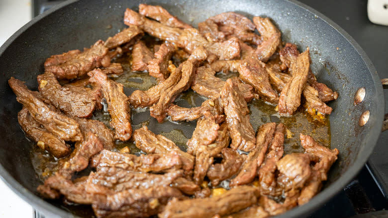 beef cooking in pan