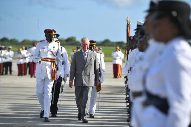 The Prince of Wales inspects a Guard of Honour as he arrives at VC Bird International Airport in Antigua