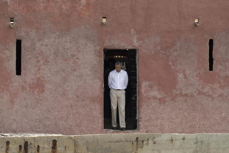 U.S. President Barack Obama looks down as he approaches the 'Door of No Return,' through which slaves once passed as they boarded ships for the Americas, at the slave house on Goree Island, in Dakar, Senegal, Thursday, June 27, 2013. Obama is calling his visit to a Senegalese island from which Africans were said to have been shipped across the Atlantic Ocean into slavery, a 'very powerful moment.' President Obama was in Dakar Thursday as part of a weeklong trip to Africa, a three-country visit aimed at overcoming disappointment on the continent over the first black U.S. president's lack of personal engagement during his first term. (AP Photo/Rebecca Blackwell)