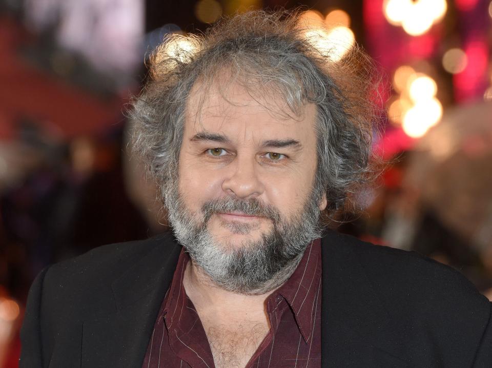 Peter Jackson in a burgundy shirt and black jacket