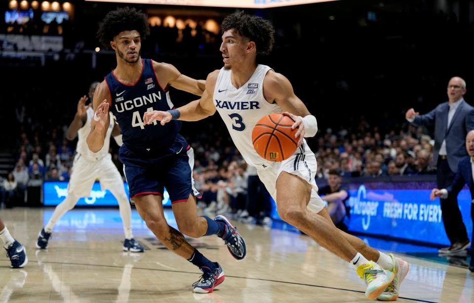 Xavier Musketeers guard Colby Jones (3) drives to the hoop around Connecticut Huskies guard Andre Jackson Jr. (44) in the first half  Saturday, December 31, 2022 at the Cintas Center. 