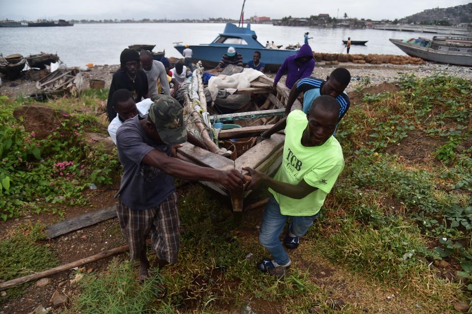 <p>Fishermen move a boat inland as Hurricane Irma approaches Cap-Haitien, on Sept. 7, 2017. The fishermen were not aware of Irma. Irma was expected to hit the northern edges of the Dominican Republic and Haiti later Thursday, continuing past eastern Cuba before veering north towards Florida. (Photo: Hector Retamal/AFP/Getty Images) </p>