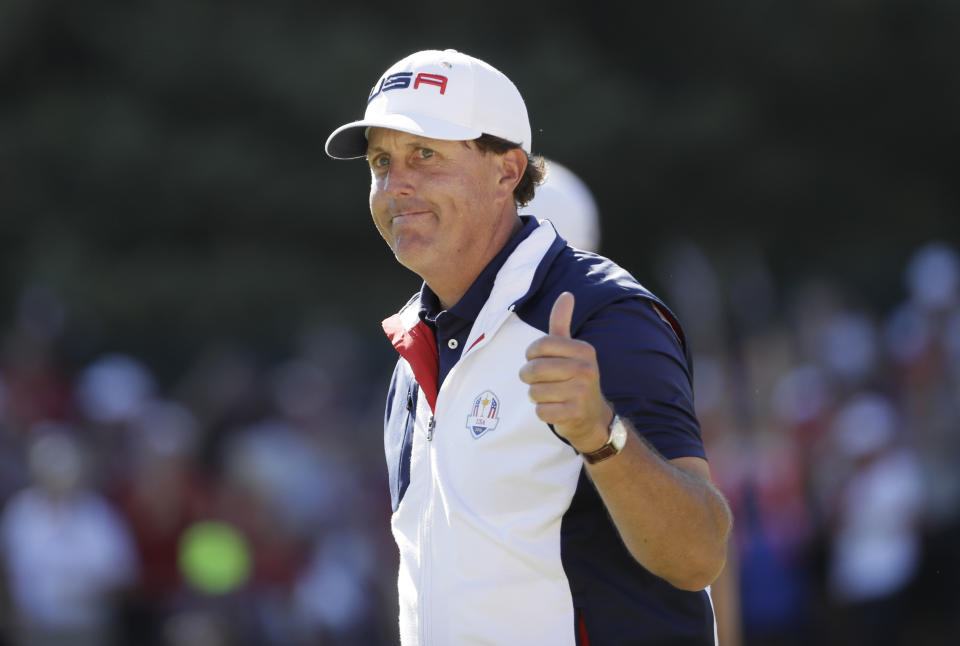 FILE - In this Oct. 2, 2016, file photo, United States' Phil Mickelson gives a thumbs-up after winning the 15th hole during a singles match at the Ryder Cup golf tournament at Hazeltine National Golf Club in Chaska, Minn. Mickelson sets a record at next week's Ryder Cup with his 12th consecutive appearance. (AP Photo/David J. Phillip, File)