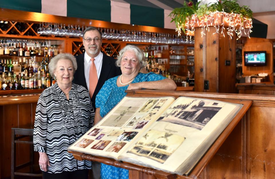 Anna, Tom and Judy Testa stand by the entrance to their restaurant in April 2015. Testa's had a scrapbook documenting the family's roots in Palm Beach.