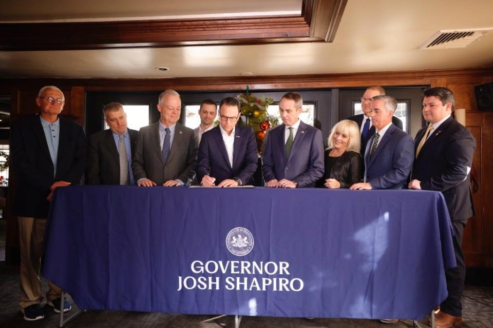 Governor Josh Shapiro, center, joined by local elected official to ceremonially sign House Bill 735 on Monday, Dec. 4 2023. HB 735 establishes the Flood Insurance Premium Assistance Task Force.