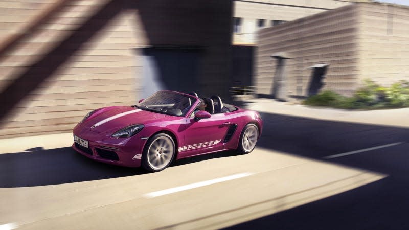 A photo of a vibrant pink Porsche Boxster convertible. 