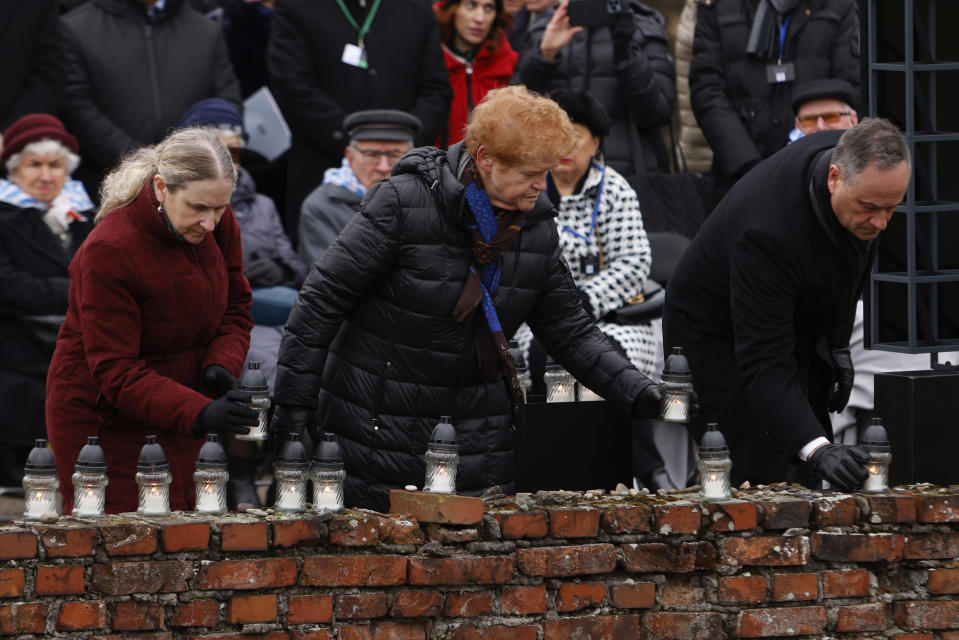 U.S. Second Gentleman, Douglas Emhoff, right, and Deborah Lipstadt, U.S. Ambassador, center, place candles at the former crematorium as they attend a ceremony in the former Nazi German concentration and extermination camp Auschwitz during ceremonies marking the 78th anniversary of the liberation of the camp in Brzezinka, Poland, Friday, Jan. 27, 2023. (AP Photo/Michal Dyjuk)