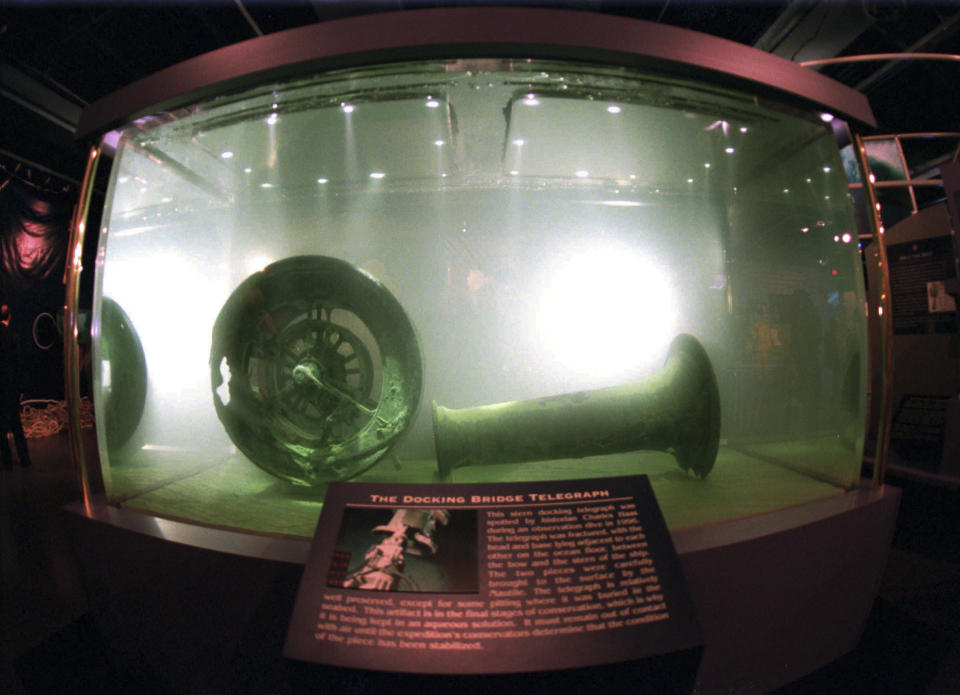 FILE - In this Nov. 26, 1996 file photo, the docking bridge telegraph recovered from the wreckage of the Titanic is displayed in a large seawater-filled tank at the Nauticus National Maritime Center in Norfolk, Va. The salvage firm that has plucked artifacts from the sunken Titanic cruise ship over the decades is seeking a judge's permission to rescue more items from the rapidly deteriorating wreck. (AP photo/Steve Helber, File)