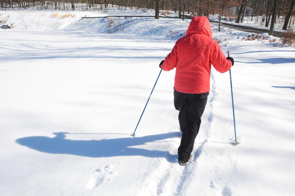 Barbara Althen of Norwich, bundled up in four layers of clothing, uses cross country poles (without the skis), walks an hour in bitter sub 20 degree cold and winds Monday at Richard Fontaine Field in Norwich. She said of the snow "I love winter and the snow. The snow looks like flakes of diamonds."