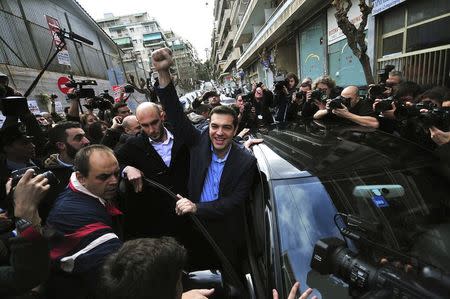 Opposition leader and head of radical leftist Syriza party Alexis Tsipras raises his fist as he leaves a polling station where he voted in Athens, Greece in this January 25, 2015 file photo. REUTERS/Alexandros Stamatiou/PHASMA/Files