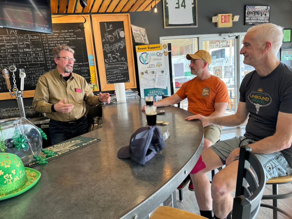 Owner Scott Hoggatt (left) and bicycling customers Rob Lewis (center) and Mike Nowak relax at the HandleBar, the "libation station" inside VeloCity Cycling in downtown Pewaukee. The bar business is expected to carry into April, but Hoggatt plans to close the retail store March 30. A buyer may still emerge, Hoggatt said.