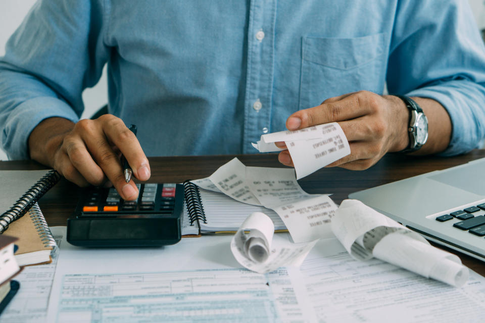 A man calculating receipts