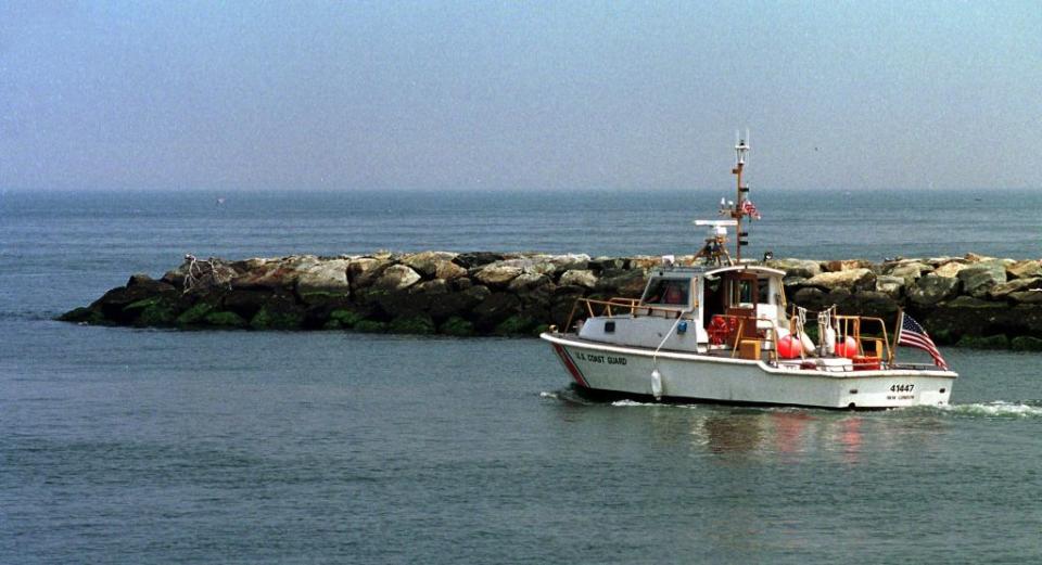 A US Coast Guard boat heads out to join the search for the missing airplane believed to be carrying John F. Kennedy Jr. and his wife Carolyn Bessette Kennedy to a family wedding in Massachusetts. AFP via Getty Images