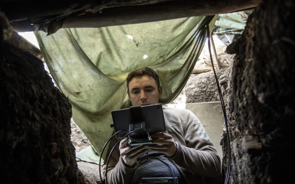 Alex, a drone operator of Brigade 28th of Ukrainian Army, scouts for enemy positions inside a trench