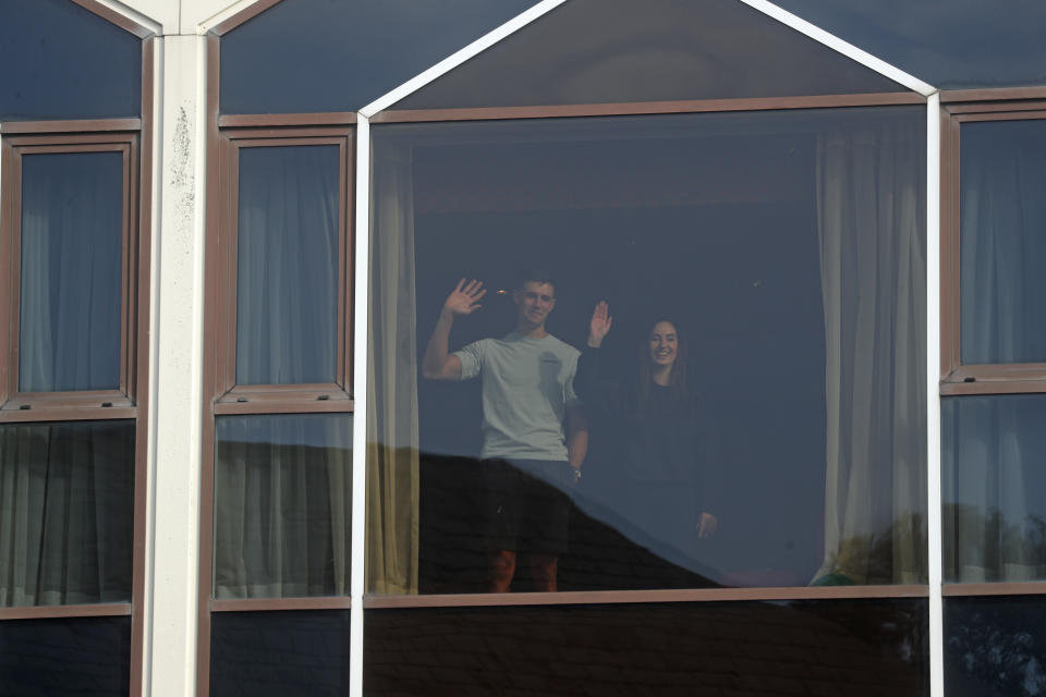 Hotel guests look out of the window at the Radisson Blu Edwardian Hotel, near Heathrow Airport, London, one of the new Government managed quarantine facilities. New regulations now in force require anyone who has been in a high-risk location to enter England through a designated port and have pre-booked a package to stay at one of the Government's managed quarantine facilities. Picture date: Monday February 15, 2021.