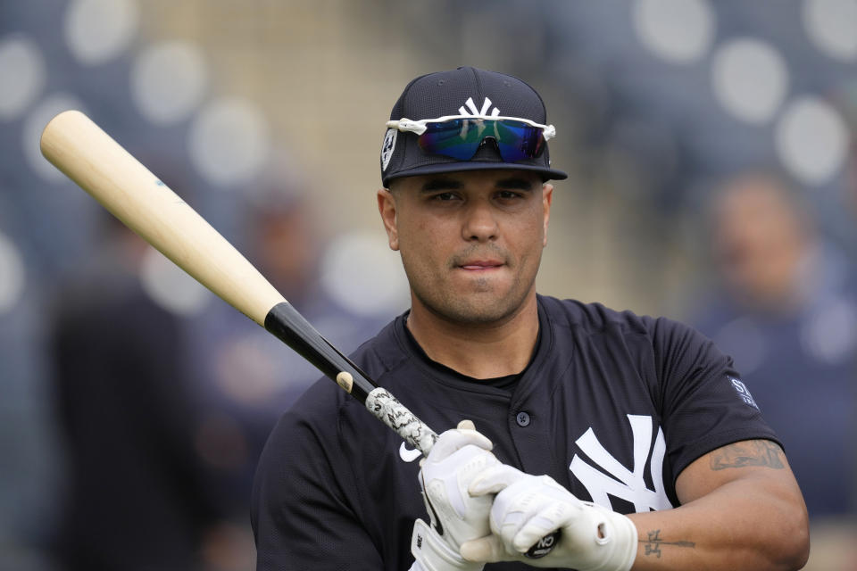 New York Yankees catcher Yoendrys Gomez stands outside the batting cage during a baseball spring training workout Thursday, Feb. 15, 2024, in Tampa, Fla. (AP Photo/Charlie Neibergall)