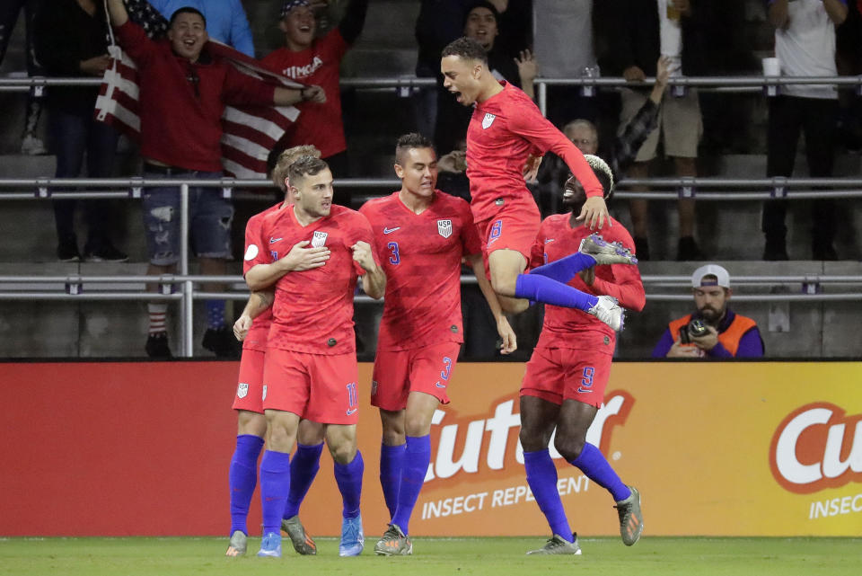 U.S. forward Jordan Morris, front left, celebrates his goal against Canada with teammates, including Aaron Long (3), Sergino Dest (18) and Gyasi Zardes (9), during the first half of a CONCACAF Nations League soccer match Friday, Nov. 15, 2019, in Orlando, Fla. (AP Photo/John Raoux)