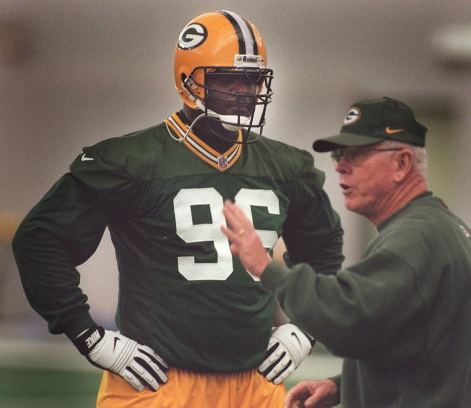 Defensive end Vaughn Booker listens to instruction by Fritz Shurmur during a minicamp for the Green Bay Packers at the Hutson Center in Green Bay June 2, 1998.