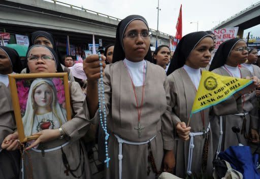Catholic nuns join some 7,000 protesters during an anti reproductive health (RH) bill rally at a Catholic shrine in Manila. Philippine nuns and priests led thousands of Catholics in a protest in Manila against a proposed law that would provide free contraceptives in a bid to curb population growth