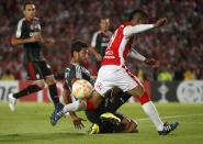 Wilson Morelo (R) of Colombia's Santa Fe fights for the ball with Sebastian Dominguez of Argentina's Estudiantes de La Plata during their Copa Libertadores soccer match in Bogota May 12, 2015. REUTERS/John Vizcaino