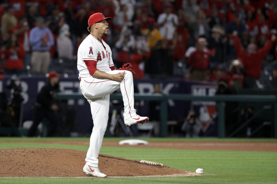 Los Angeles Angels relief pitcher Hansel Robles celebrates the team's 4-3 win over the Toronto Blue Jays in a baseball game in Anaheim, Calif., Tuesday, April 30, 2019. (AP Photo/Chris Carlson)